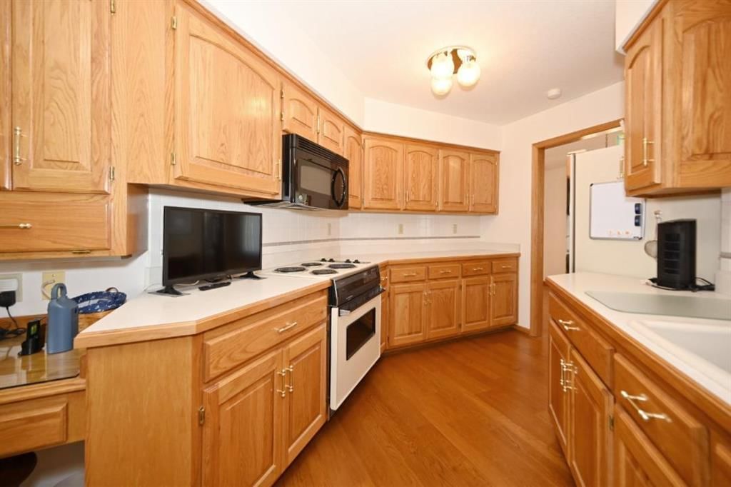 Electric range and white countertops at 14 Pine View Road, Platte City, MO 64079
