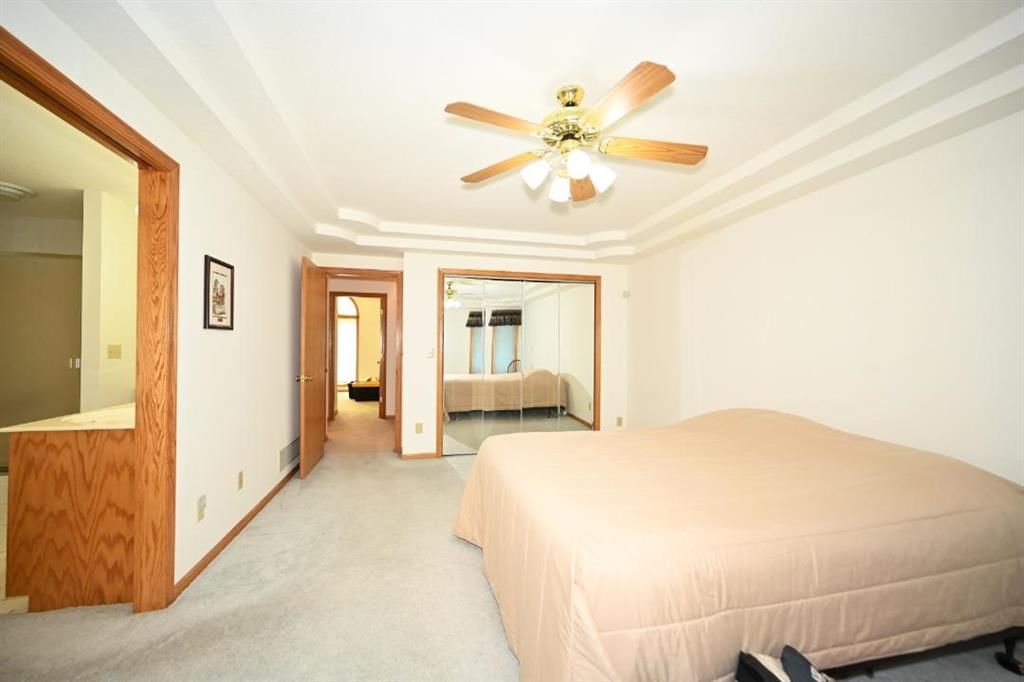 Main-floor primary bedroom and tray ceiling at 14 Pine View Road, Platte City, MO 64079