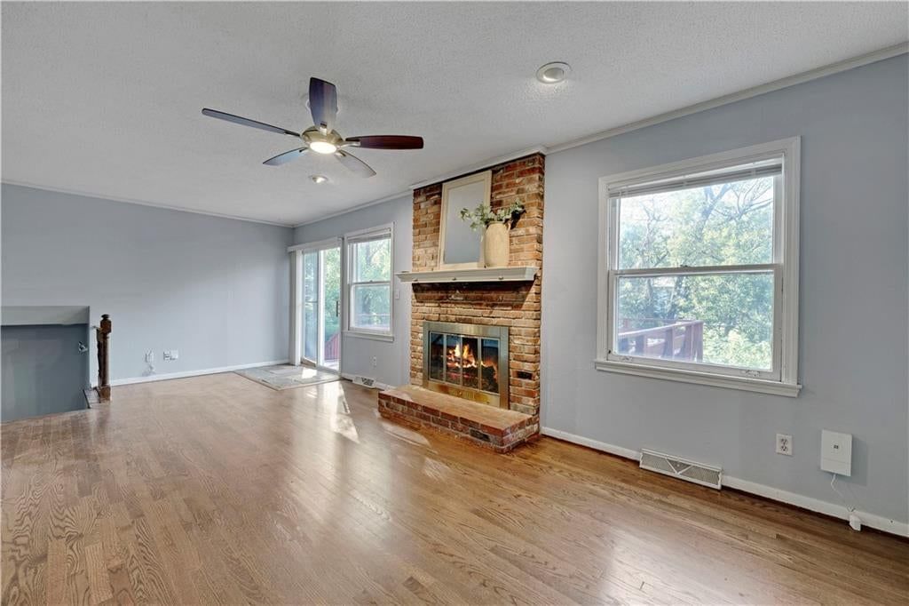 Fireplace, open floor plan and brick fireplace at 10130 Horton Drive, Overland Park, KS 66207