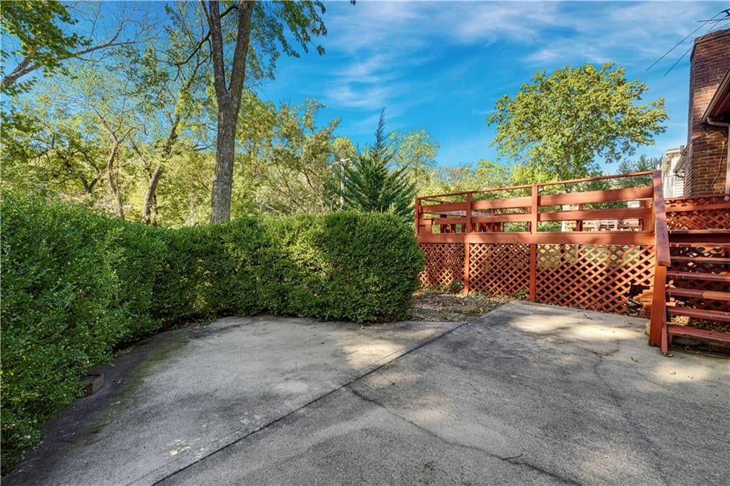 Fenced yard, concrete driveway and wood fence at 10130 Horton Drive, Overland Park, KS 66207
