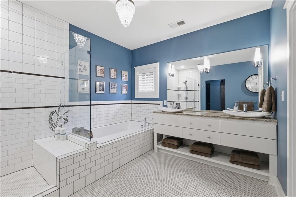 Walk-in shower, tiled shower and double vanity at 43 L Street, Lake Lotawana, MO 64086