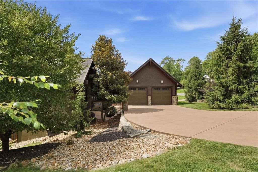Garage for three or more cars, attached garage and concrete driveway at 43 L Street, Lake Lotawana, MO 64086