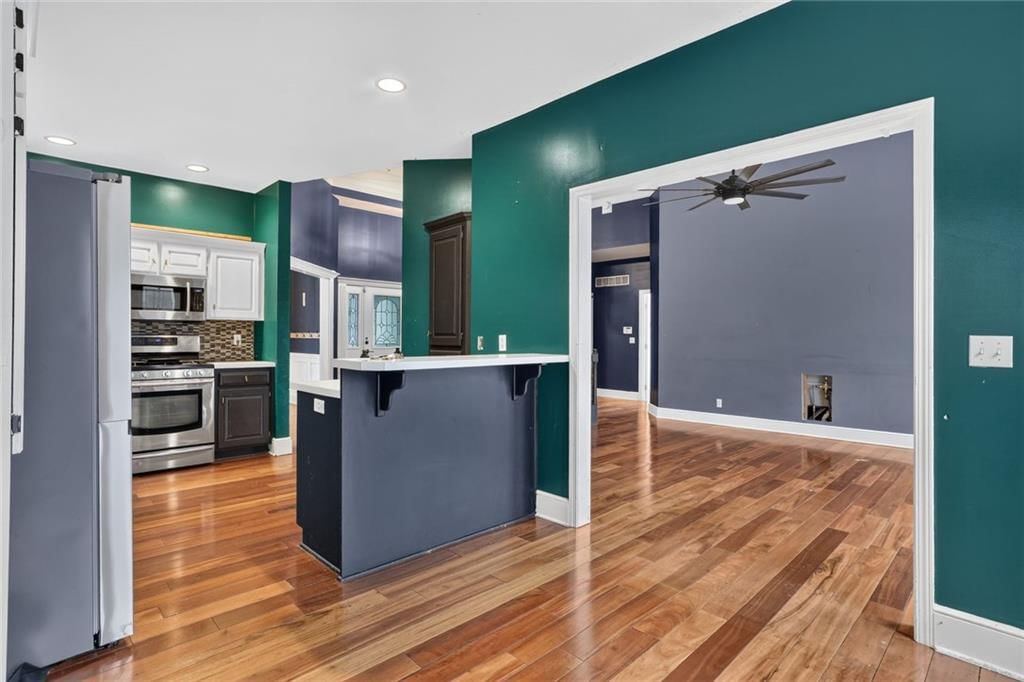 Open floor plan, kitchen island and quartz counters at 413 Shannon Avenue, Smithville, MO 64089