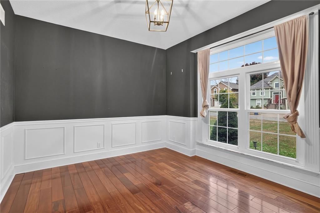 Hardwood floors, wainscoting or board and batten and white trim at 413 Shannon Avenue, Smithville, MO 64089