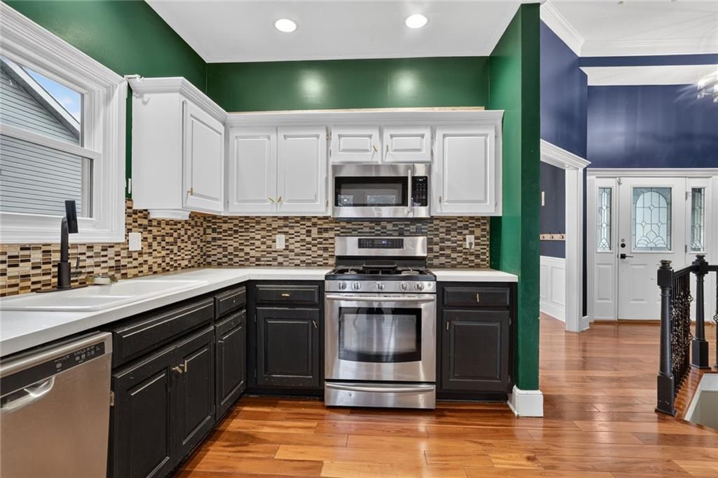 Stainless steel appliances and kitchen backsplash at 413 Shannon Avenue, Smithville, MO 64089