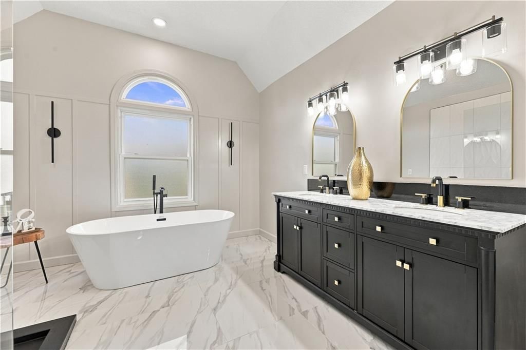 Freestanding tub, double vanity and black vanity at 8517 W 145th Terrace, Overland Park, KS 66223