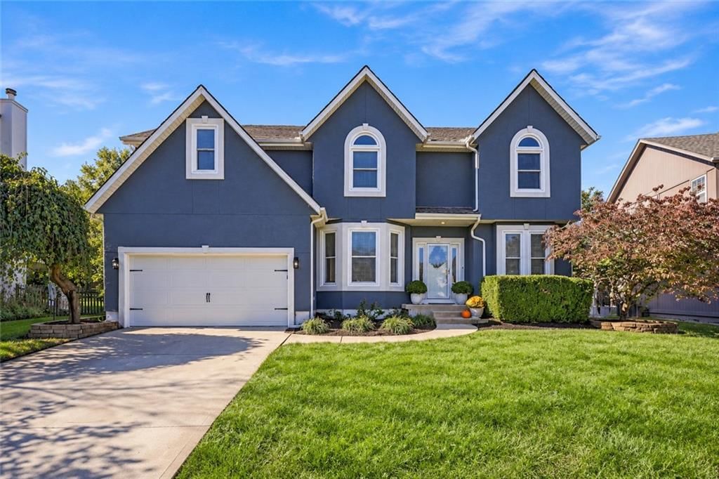 Stucco exterior, attached garage and brown roof at 8517 W 145th Terrace, Overland Park, KS 66223
