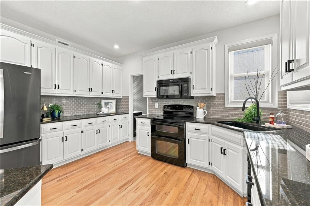 Granite counters, double oven and electric range at 8517 W 145th Terrace, Overland Park, KS 66223