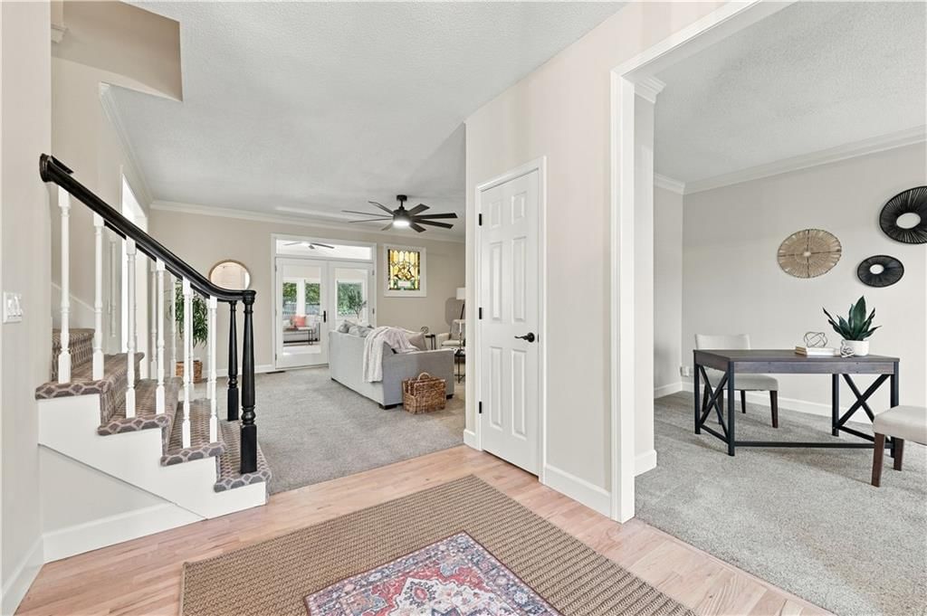 Staircase, wood stair railing and black hardware at 8517 W 145th Terrace, Overland Park, KS 66223