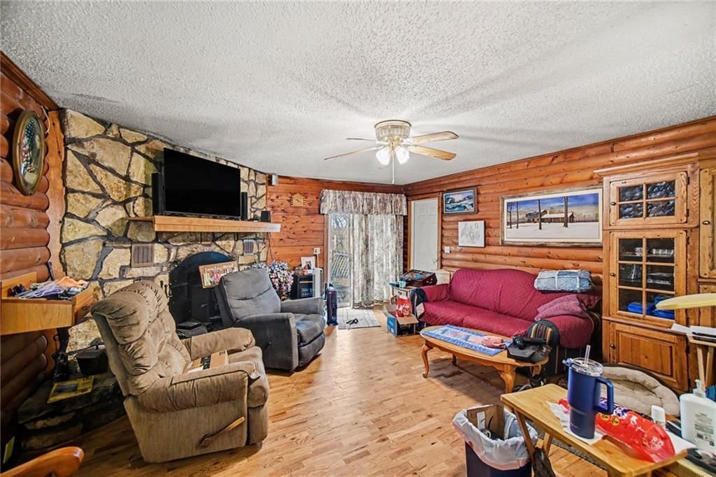 Fireplace, statement lighting and stone fireplace at 6810 NW Martin Road, Kansas City, MO 64163