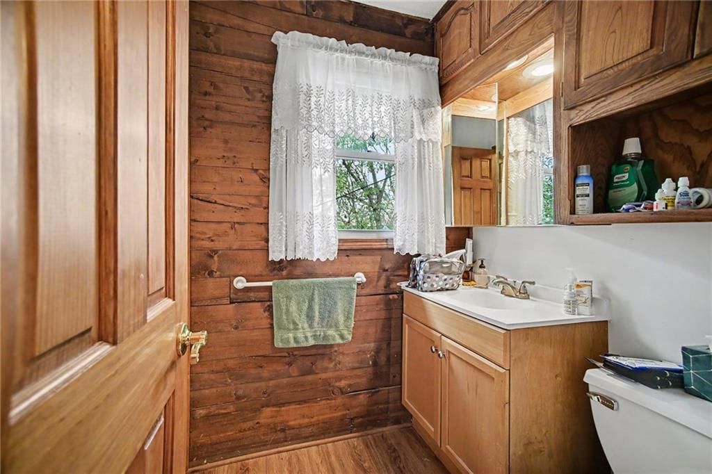 Tiled shower and wood vanity at 6810 NW Martin Road, Kansas City, MO 64163