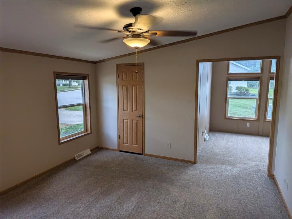 Main-floor primary bedroom at 846 NE White Oaks Lane, Oak Grove, MO 64075