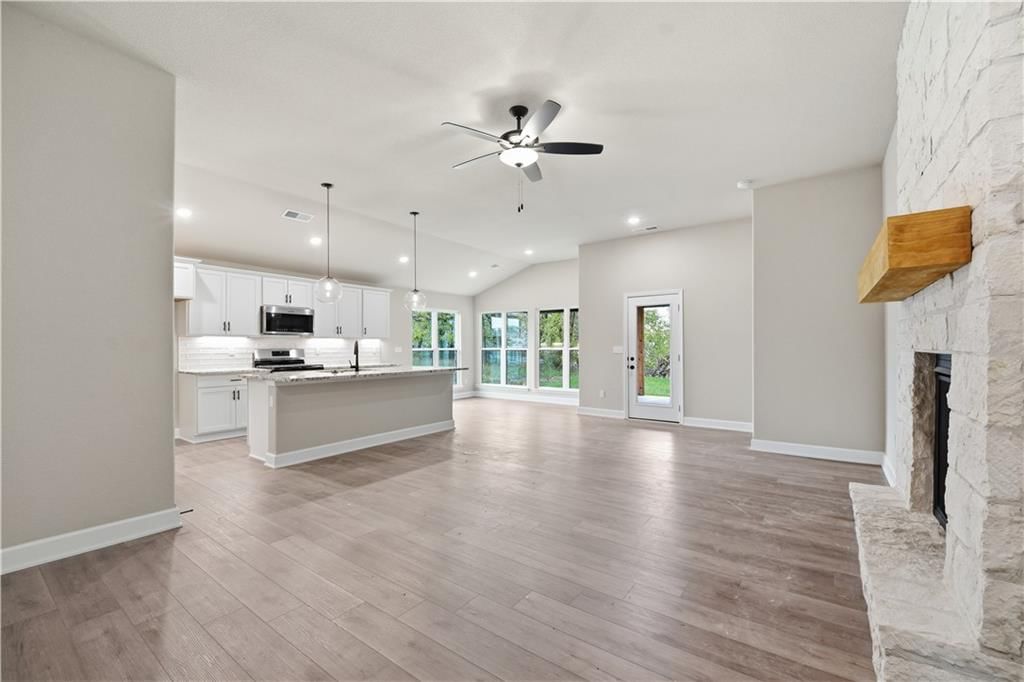 Fireplace, open floor plan and brick fireplace at 18450 W 195th Street, Spring Hill, KS 66083