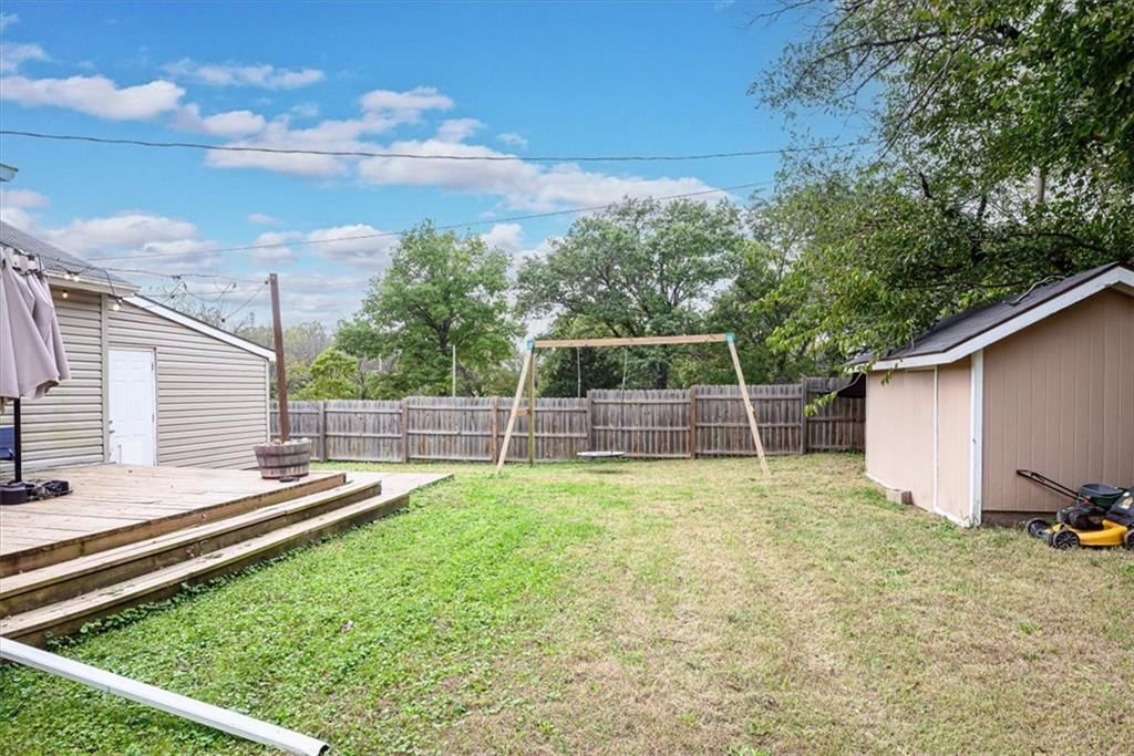 Deck, big backyard and fenced yard at 102 W Kansas Avenue, Lansing, KS 66048