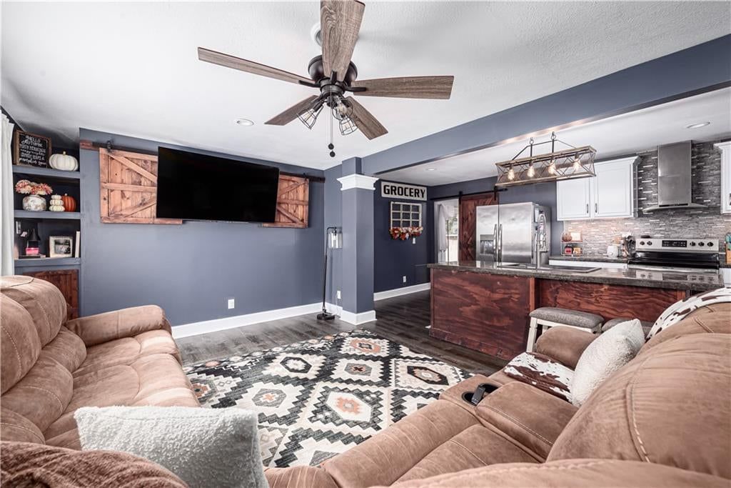 Fireplace, open floor plan and brick fireplace at 102 W Kansas Avenue, Lansing, KS 66048