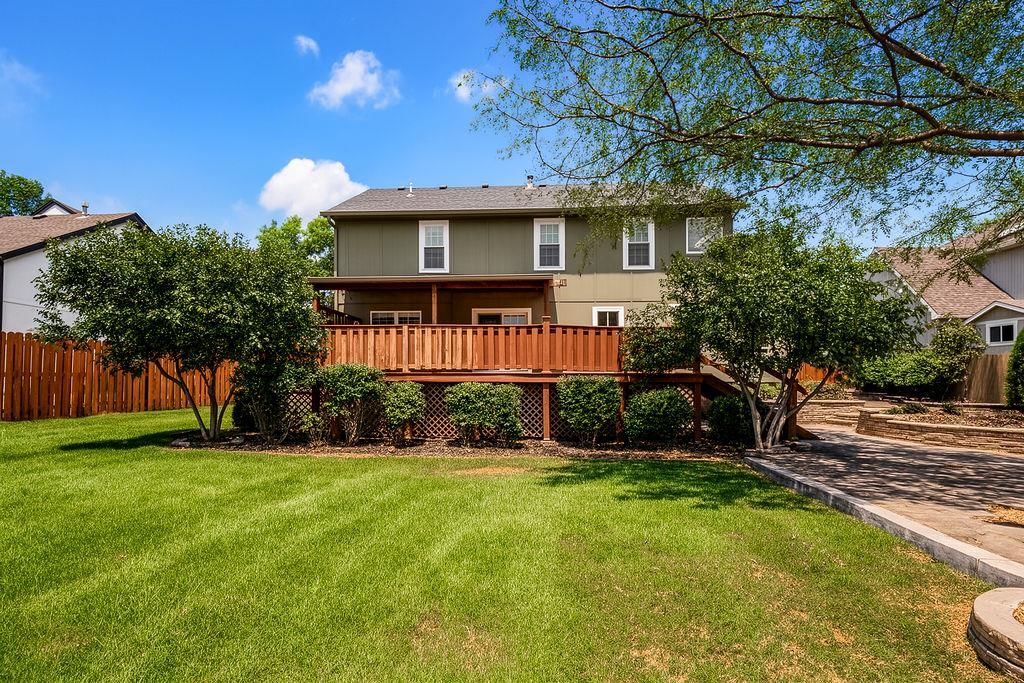 Covered front porch and fenced yard at 9921 N Highland Place, Kansas City, MO 64155
