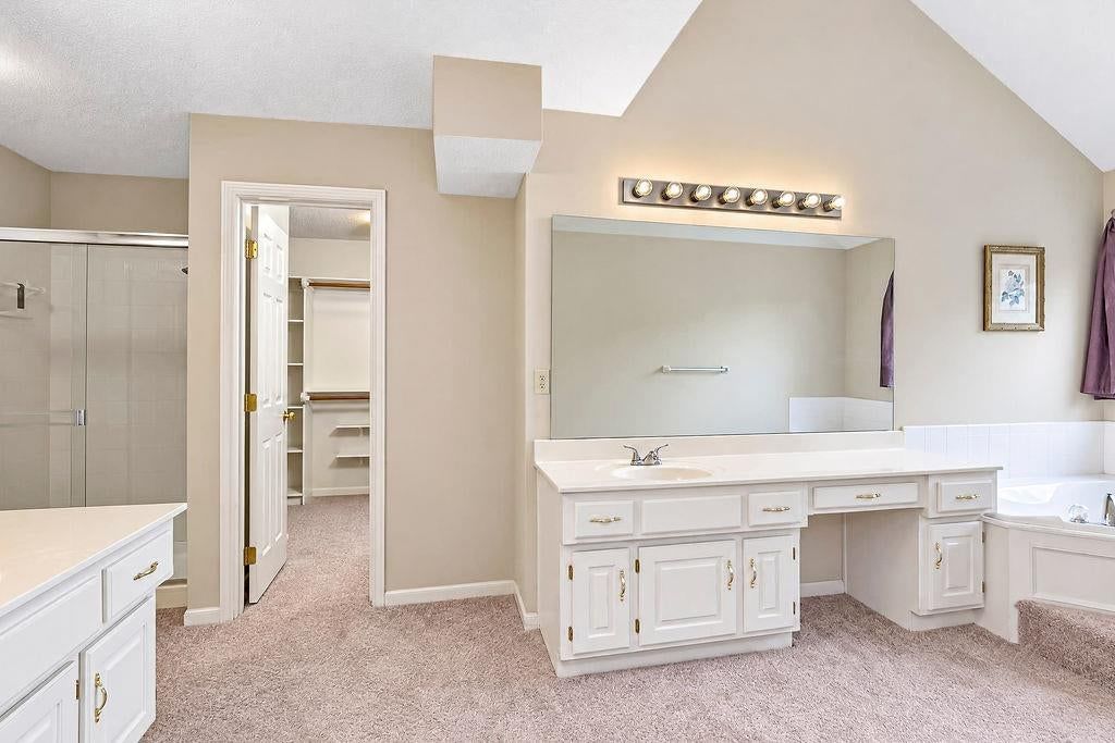 White vanity and walk-in closet at 9921 N Highland Place, Kansas City, MO 64155
