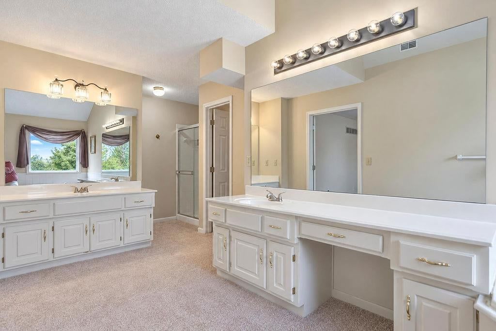 Walk-in shower, tiled shower and frameless glass shower at 9921 N Highland Place, Kansas City, MO 64155