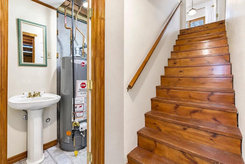 Staircase and wood stair railing at 9921 N Highland Place, Kansas City, MO 64155