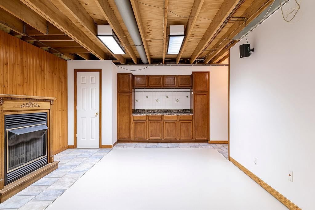 Finished basement and ceiling beams at 9921 N Highland Place, Kansas City, MO 64155