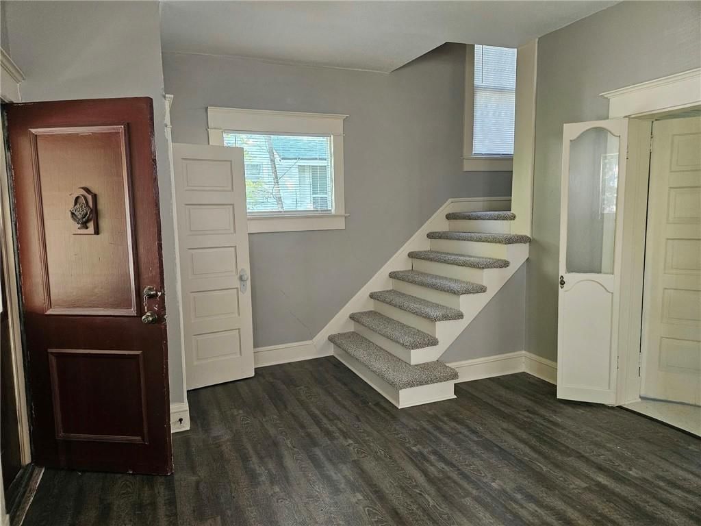 Open floor plan and open-riser staircase at 1733 S Crescent Avenue, Independence, MO 64052