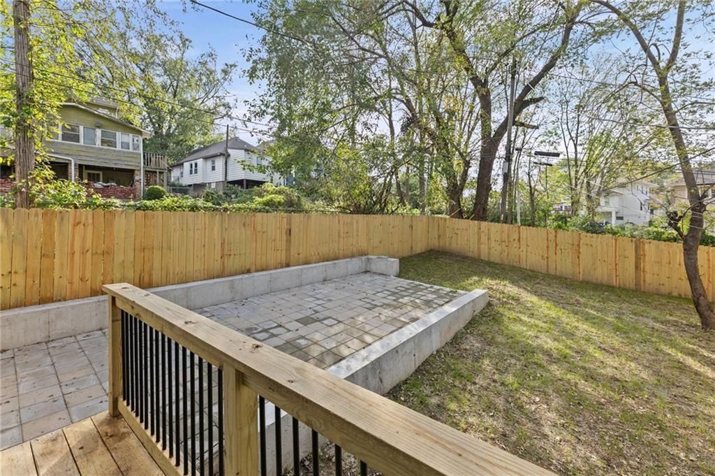 Deck, fenced yard and paver patio at 1111 Kimball Avenue, Kansas City, KS 66104