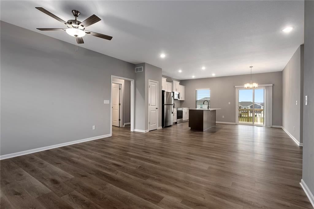 Hardwood floors, recessed lighting and white trim at 524 Lemon Mint Drive, Raymore, MO 64083