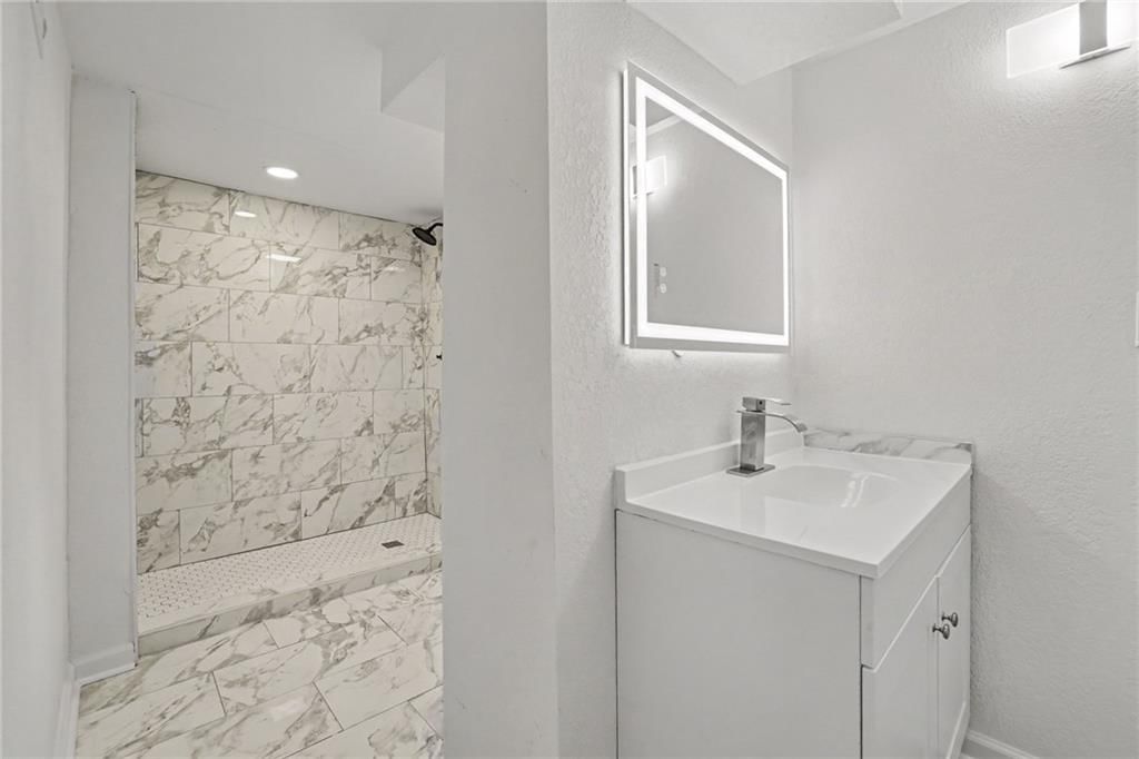 Walk-in shower and tiled shower at 8507 Kentucky Avenue, Raytown, MO 64138