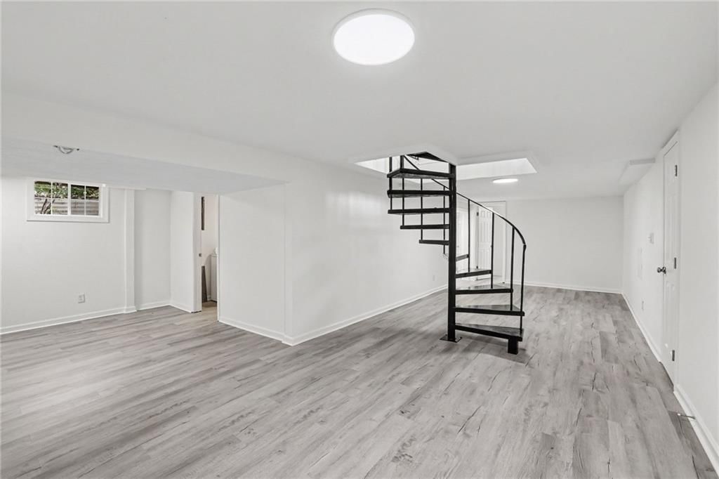 Finished basement, curved staircase and staircase at 8507 Kentucky Avenue, Raytown, MO 64138