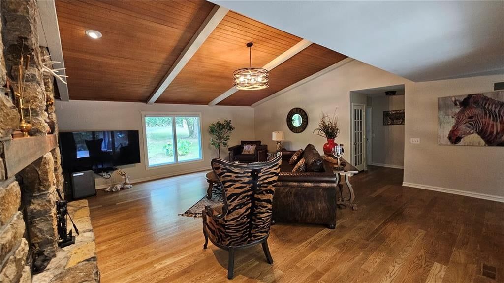 Fireplace, open floor plan and stone fireplace at 12580 S Red Bird Lane, Olathe, KS 66061
