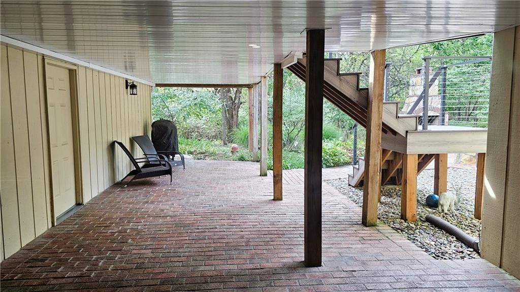 Covered patio, staircase and mixed stair railing at 12580 S Red Bird Lane, Olathe, KS 66061