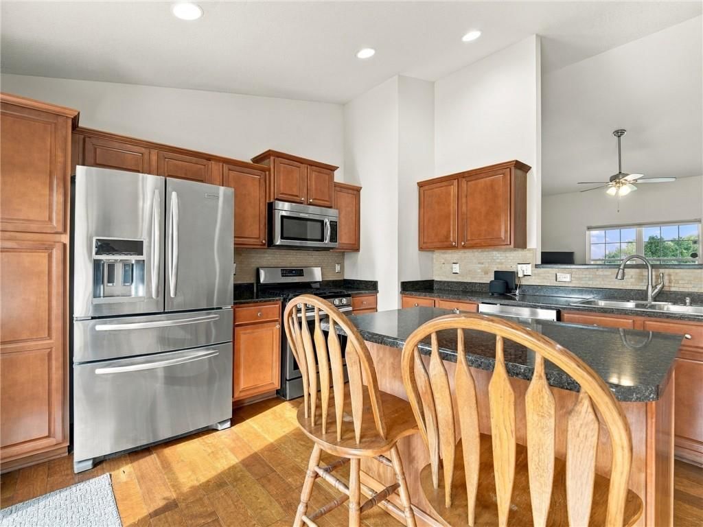 Kitchen island, breakfast nook and kitchen backsplash at 7305 E 143rd Street, Grandview, MO 64030