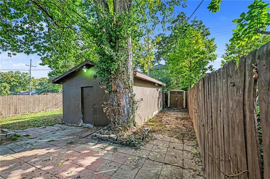 Fenced yard, mature trees and wood fence at 1305 S 40th Street, Kansas City, KS 66106