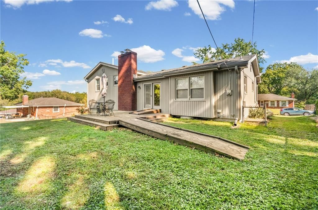 Fenced yard, covered patio and siding exterior at 7512 N Baltimore Avenue, Gladstone, MO 64118
