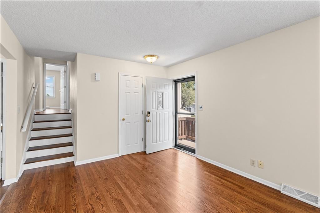 Open-riser staircase, staircase and wood stair railing at 7512 N Baltimore Avenue, Gladstone, MO 64118