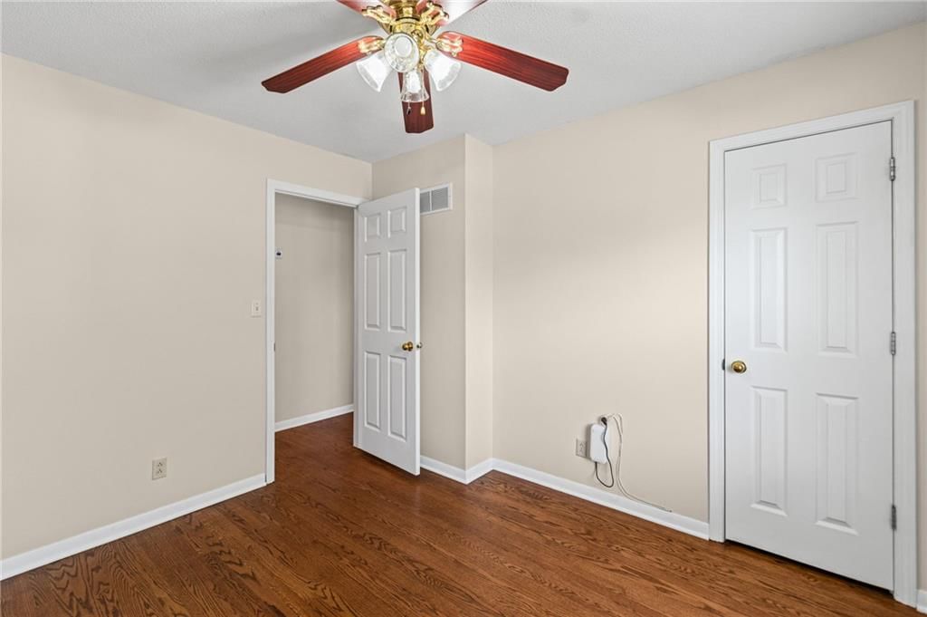 Hardwood floors, walk-in closet and white trim at 7512 N Baltimore Avenue, Gladstone, MO 64118