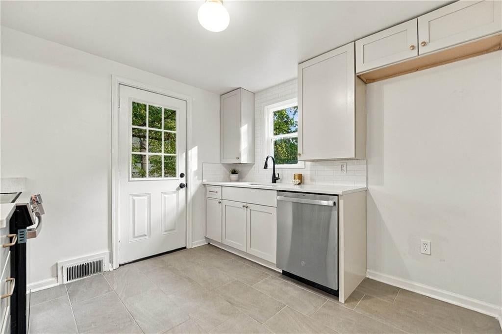 Quartz counters, shaker cabinets and updated kitchen at 7929 Madison Avenue, Kansas City, MO 64114