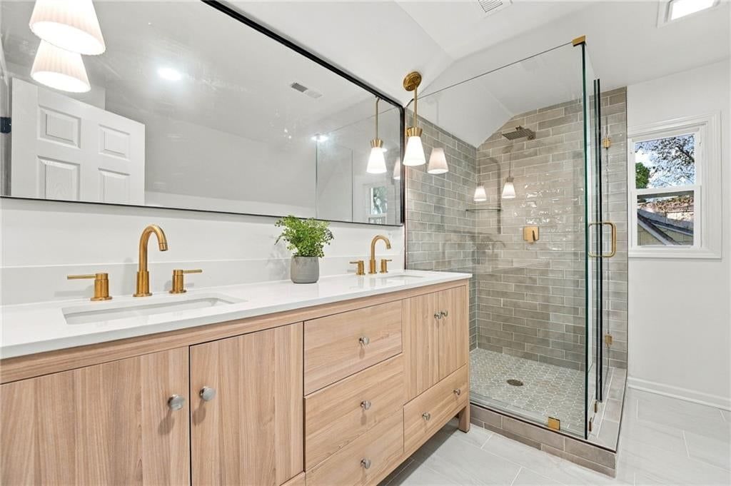 Walk-in shower, private toilet room and double vanity at 7929 Madison Avenue, Kansas City, MO 64114