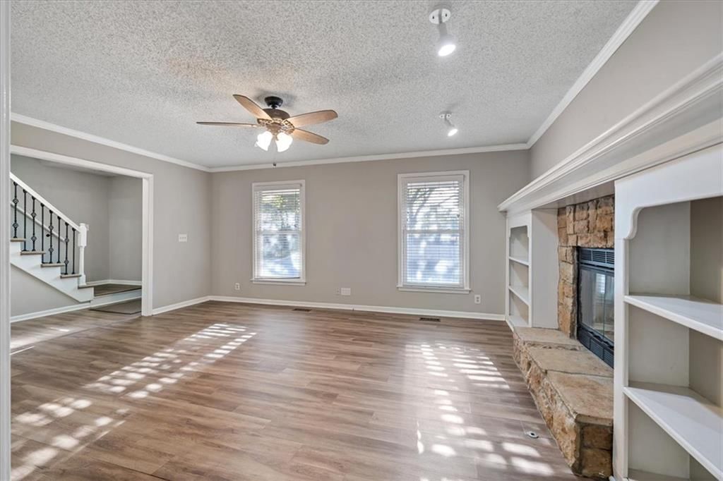 Fireplace, floor-to-ceiling windows and stone fireplace at 1425 N Hunter Drive, Olathe, KS 66061