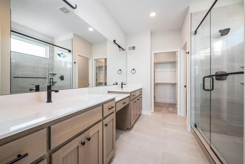 Walk-in shower, tiled shower and double vanity at 14617 Aspen Circle, Basehor, KS 66007