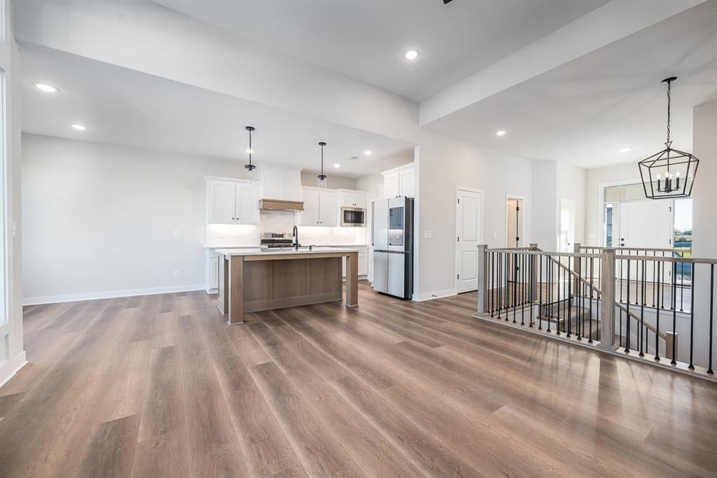 Tall ceilings, statement lighting and staircase at 14617 Aspen Circle, Basehor, KS 66007