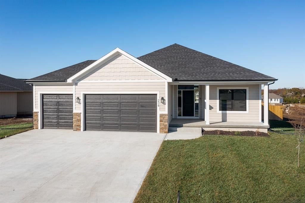 Ranch-style home, garage for three or more cars and white exterior at 14617 Aspen Circle, Basehor, KS 66007