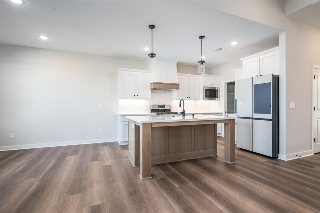 Kitchen island, white kitchen and quartz counters at 14617 Aspen Circle, Basehor, KS 66007