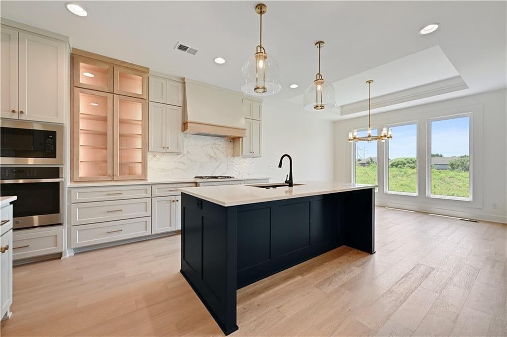 Kitchen island, white kitchen and quartz counters at 15300 W 161st Court, Olathe, KS 66062