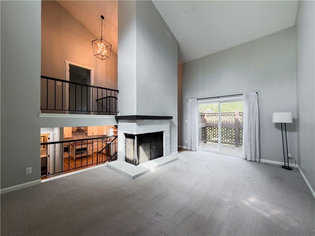 Tall ceilings, fireplace and statement lighting at 11915 W 66th Terrace, Shawnee, KS 66216