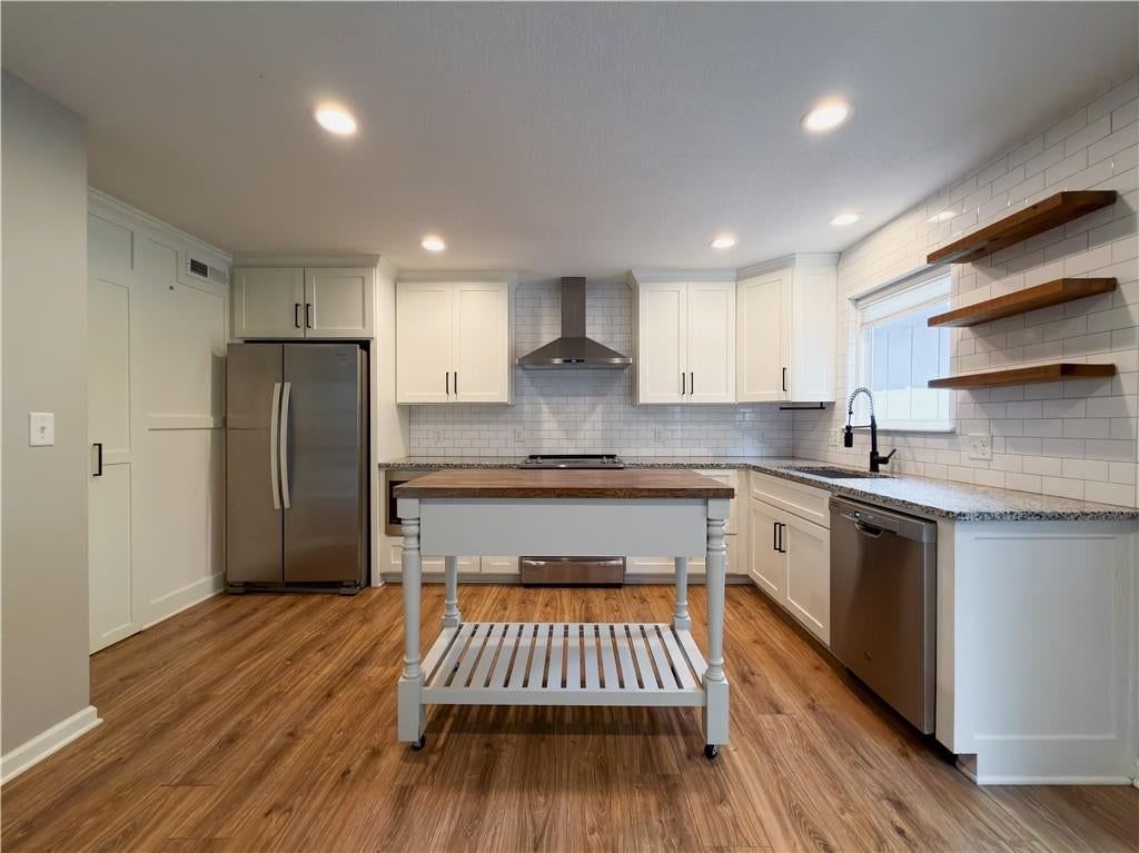 Kitchen island, white kitchen and granite counters at 11915 W 66th Terrace, Shawnee, KS 66216