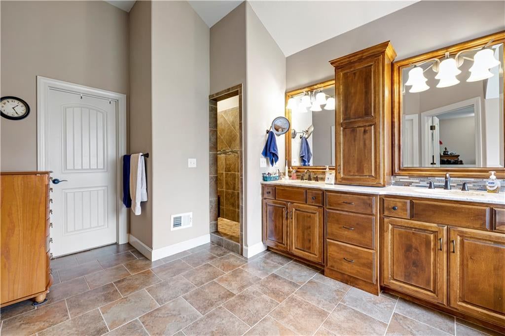 Tiled shower and renovated bathrooms at 4323 NE Park Trails Court, Lee's Summit, MO 64064
