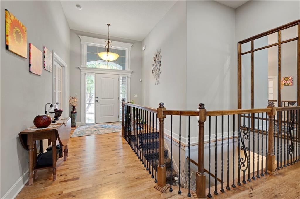 Hardwood floors, recessed lighting and staircase at 4323 NE Park Trails Court, Lee's Summit, MO 64064