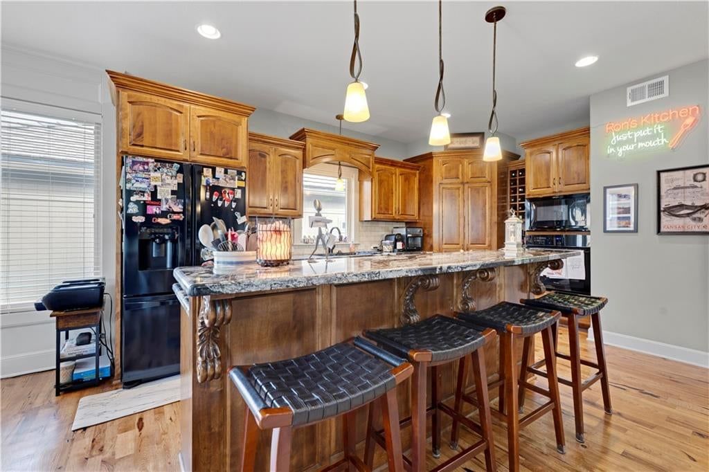 Granite counters, subway tile backsplash and veined countertops at 4323 NE Park Trails Court, Lee's Summit, MO 64064