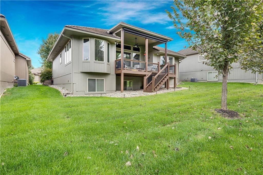 Big backyard, metal roof and driveway at 4323 NE Park Trails Court, Lee's Summit, MO 64064